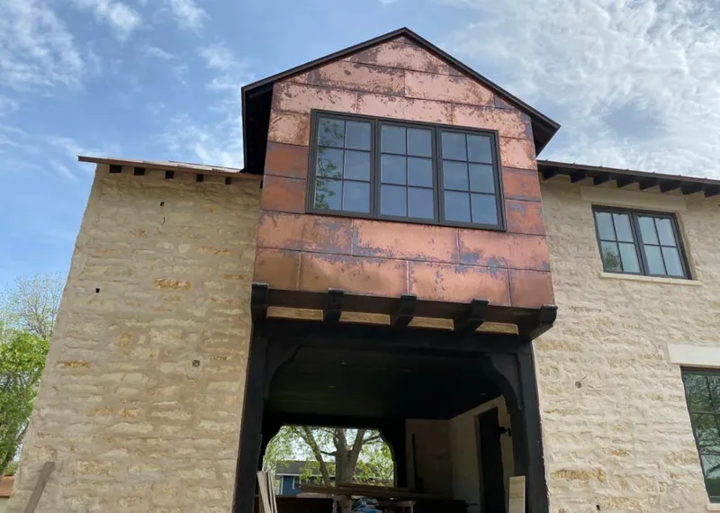 Copper metal panel facade on a stone building for Skylight Installation in Herculaneum